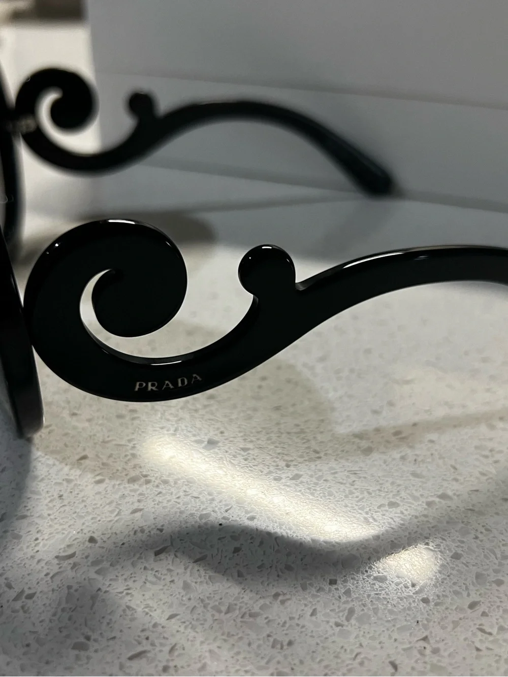 Prada Black Round Sunglasses with Swirl Arms